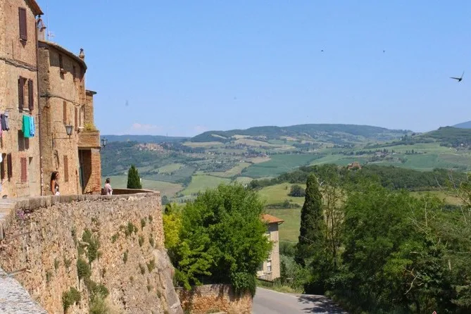 A hill town street with a view over green countryside